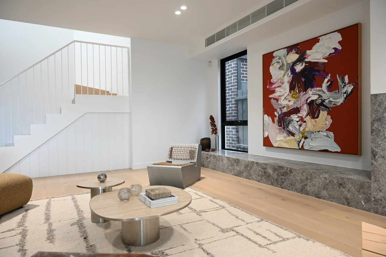 Oak staircase and grey marble in the Noga Avenue living room